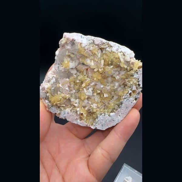 Yellow stilbite sprays with feldspar and quartz on a plate from Yunxiao, Fujian — detail view