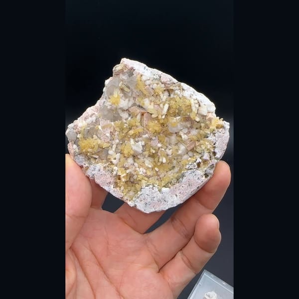Yellow stilbite sprays with feldspar and quartz on a plate from Yunxiao, Fujian — detail view