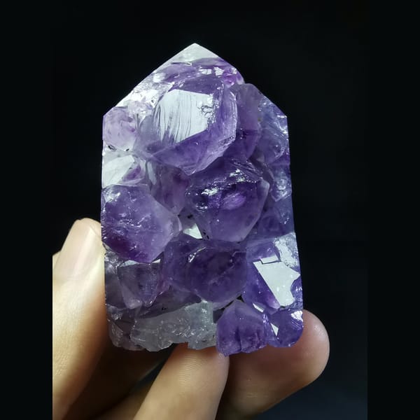 Polished Uruguayan amethyst tower with large points — complete view