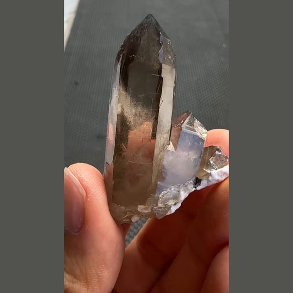 Tall smoky quartz point with smaller crystals from Yunxiao, Fujian — complete view