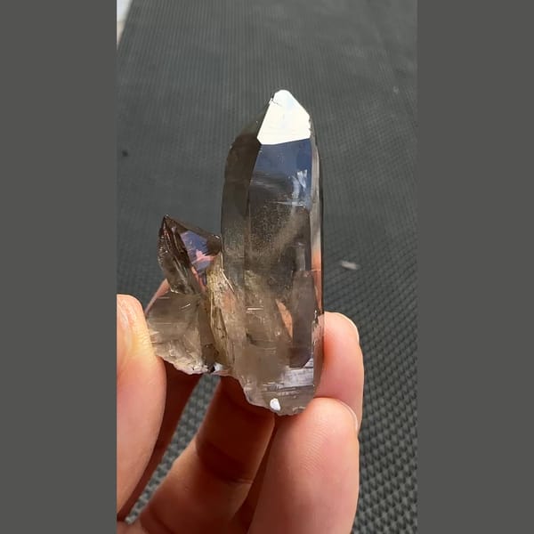 Tall smoky quartz point with smaller crystals from Yunxiao, Fujian — alternate view