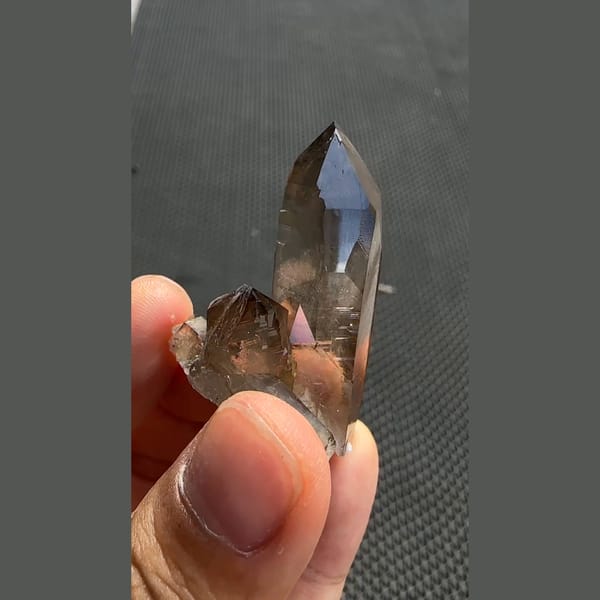 Tall smoky quartz point with smaller crystals from Yunxiao, Fujian — alternate view