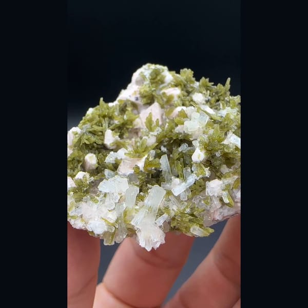White laumontite with olive epidote and pink feldspar from Yunxiao, Fujian — detail view