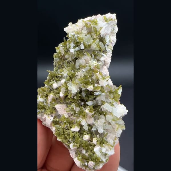 White laumontite with olive epidote and pink feldspar from Yunxiao, Fujian — detail view