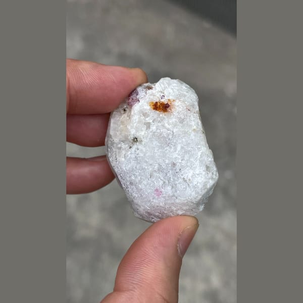 Rough red ruby corundum crystals in white matrix from Yunnan — detail view