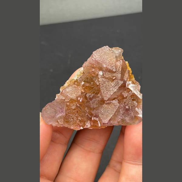 Glassy amber-brown fluorite crystal group from Zhejiang — detail view