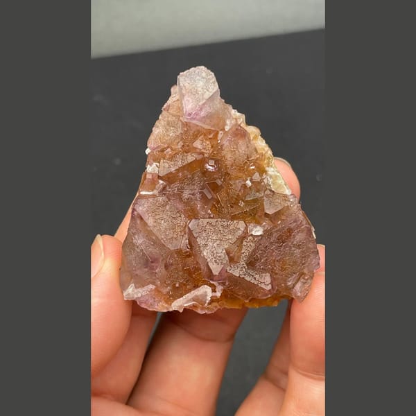 Glassy amber-brown fluorite crystal group from Zhejiang — detail view