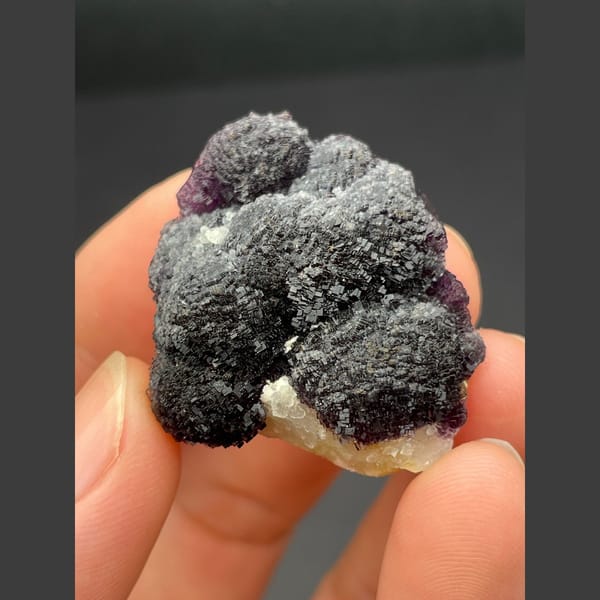 Dark purple fluorite with layered stepped growth from Henan — complete view