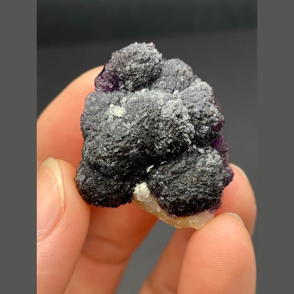 Dark purple fluorite with layered stepped growth from Henan — alternate view