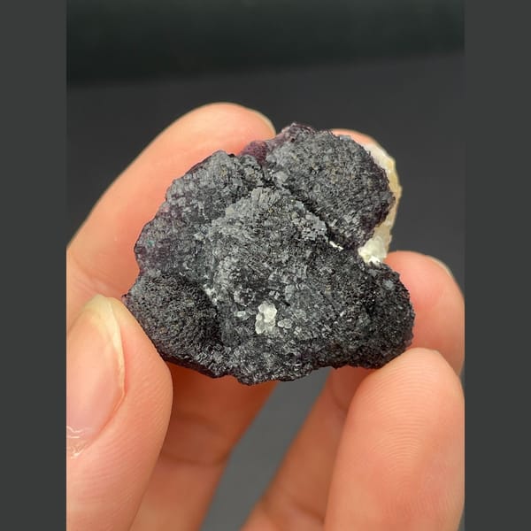 Dark purple fluorite with layered stepped growth from Henan — alternate view