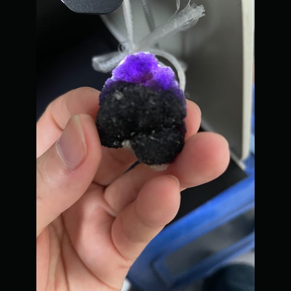 Dark purple fluorite with layered stepped growth from Henan — detail view