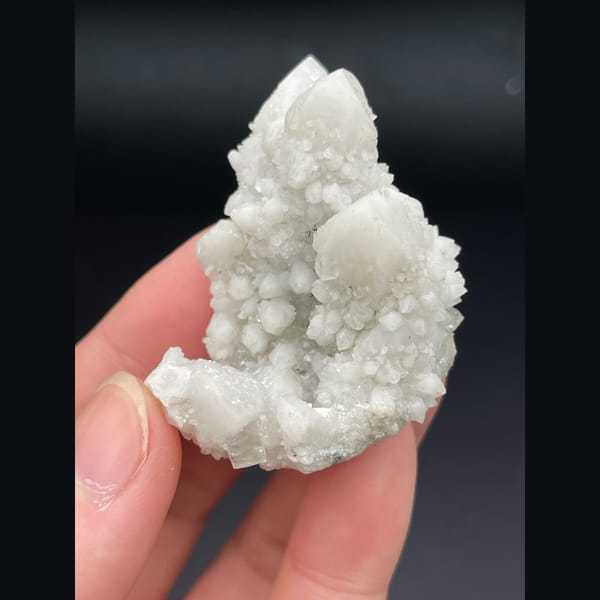 Small cluster of milky white quartz points from Inner Mongolia — alternate view