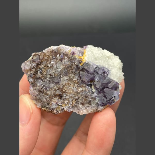 Deep purple fluorite cubes on brown matrix from Inner Mongolia — detail view