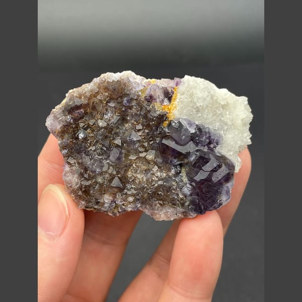 Deep purple fluorite cubes on brown matrix from Inner Mongolia — detail view