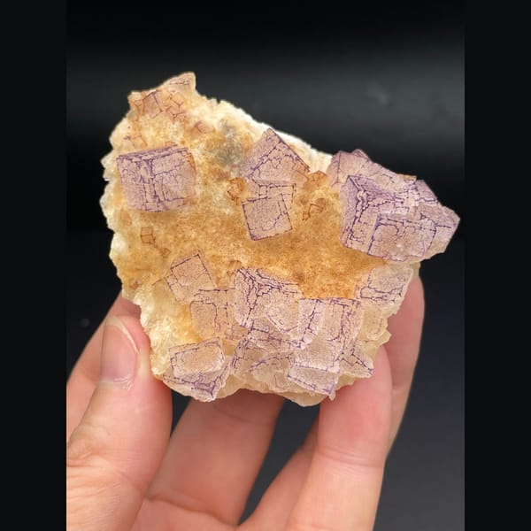 Pink lavender fluorite plate with patterned orange coating from Guizhou — detail view