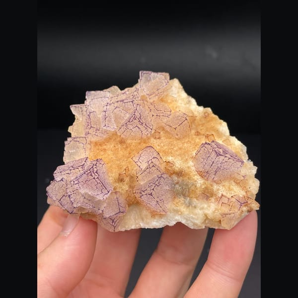 Pink lavender fluorite plate with patterned orange coating from Guizhou — detail view