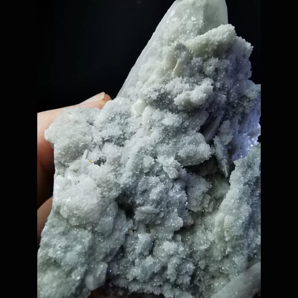 Quartz cluster with sparkling white calcite plates — detail view