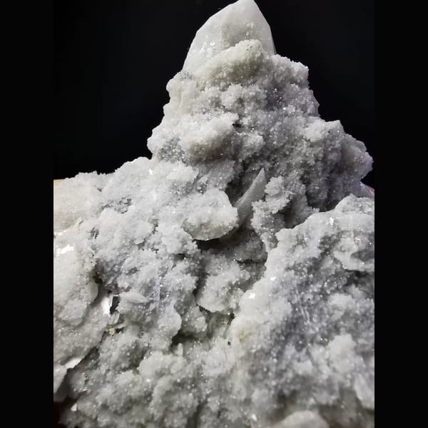 Quartz cluster with sparkling white calcite plates — detail view