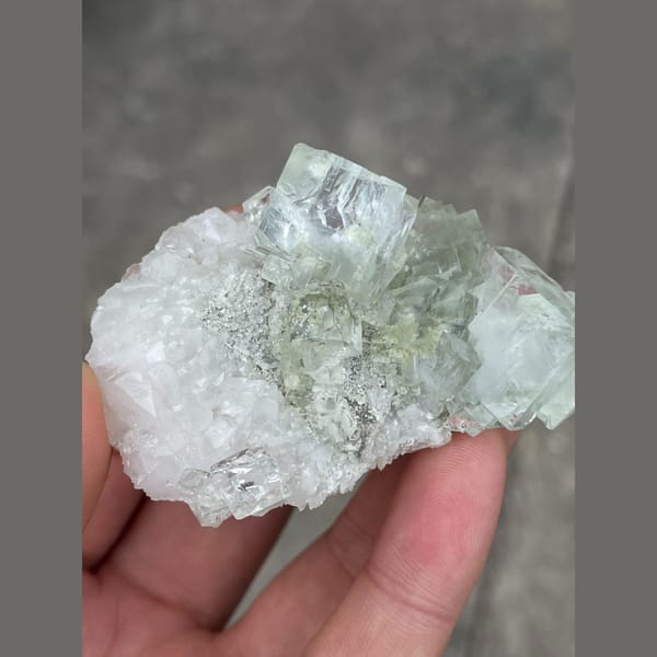 Clear mint green fluorite on white matrix from Xianghuapu — complete view