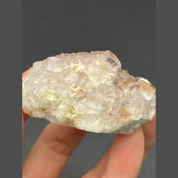 Cluster of pale pink fluorite crystals from Guizhou — detail view