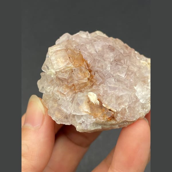 Cluster of pale pink fluorite crystals from Guizhou — detail view