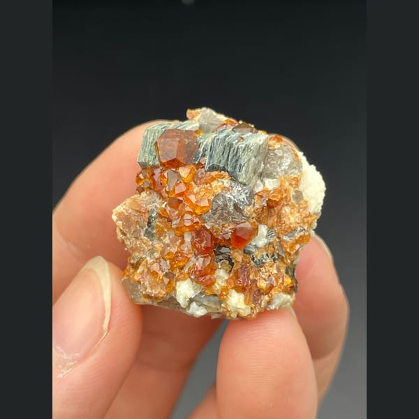 Orange spessartine garnet with smoky quartz and mica from Fujian — alternate view