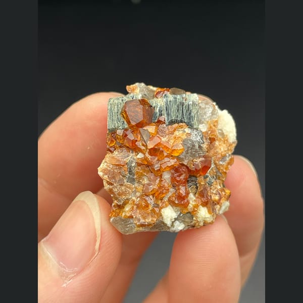 Orange spessartine garnet with smoky quartz and mica from Fujian — alternate view