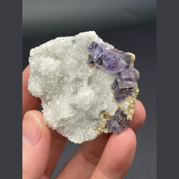 Purple fluorite cubes on a white quartz plate from Inner Mongolia — complete view