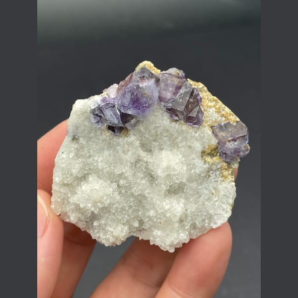 Purple fluorite cubes on a white quartz plate from Inner Mongolia — alternate view