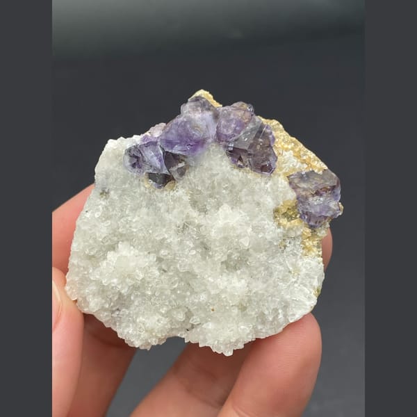 Purple fluorite cubes on a white quartz plate from Inner Mongolia — alternate view
