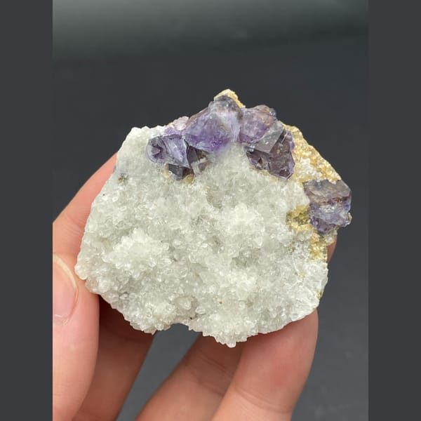 Purple fluorite cubes on a white quartz plate from Inner Mongolia — detail view