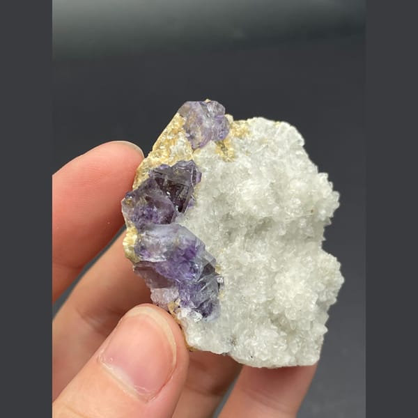 Purple fluorite cubes on a white quartz plate from Inner Mongolia — detail view