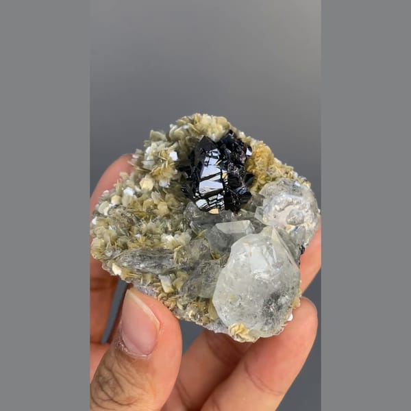 Black cassiterite with pale aquamarine on mica from Xuebaoding, Sichuan — alternate view