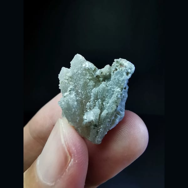 Sparkly small quartz cluster with calcite — complete view
