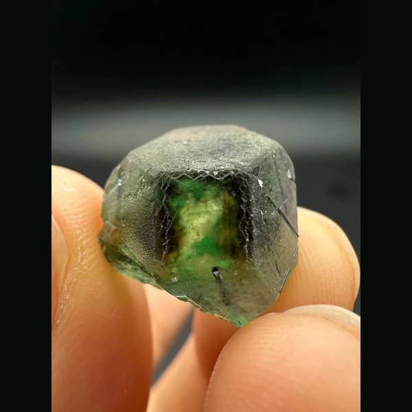 Green fluorite from Namibia, complete front view with frosted faces and dark green central zoning