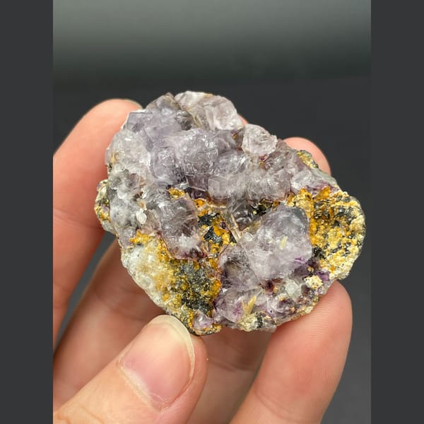 Pale lavender fluorite cubes on golden matrix from Inner Mongolia — alternate view