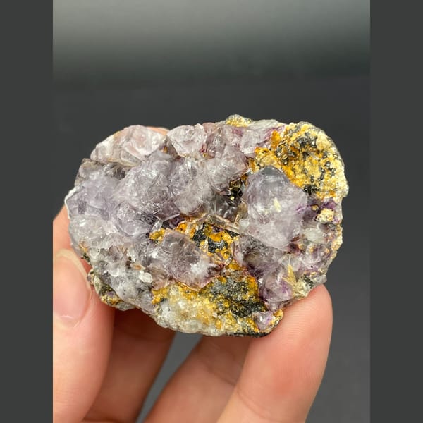 Pale lavender fluorite cubes on golden matrix from Inner Mongolia — detail view
