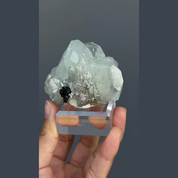 Pale green-blue aquamarine with black cassiterite from Xuebaoding, Sichuan — complete view
