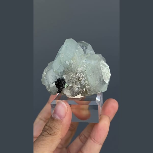 Pale green-blue aquamarine with black cassiterite from Xuebaoding, Sichuan — alternate view