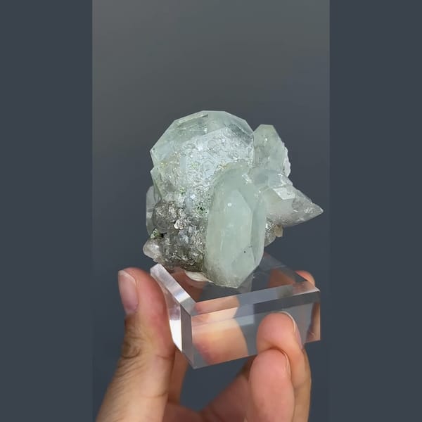 Pale green-blue aquamarine with black cassiterite from Xuebaoding, Sichuan — detail view