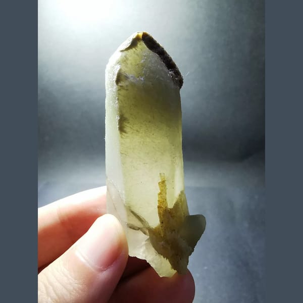 Quartz with a green inclusion at the tip — alternate view