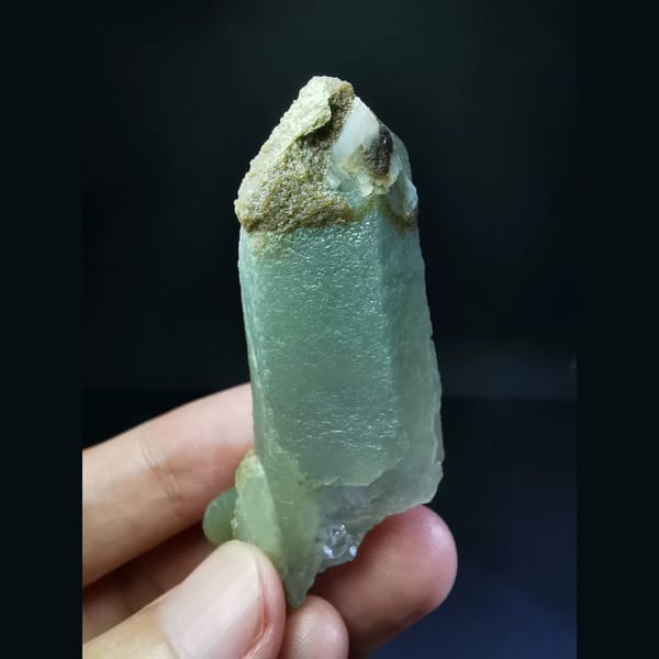Quartz with a green inclusion at the tip — detail view