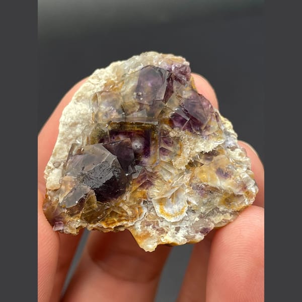 Dark purple fluorite cubes on golden matrix from Inner Mongolia — complete view