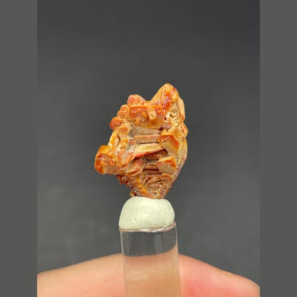 Skeletal red-orange vanadinite crystal group from Morocco — detail view