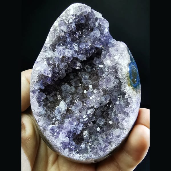 Deep Uruguayan amethyst geode with a blue agate rim — complete view