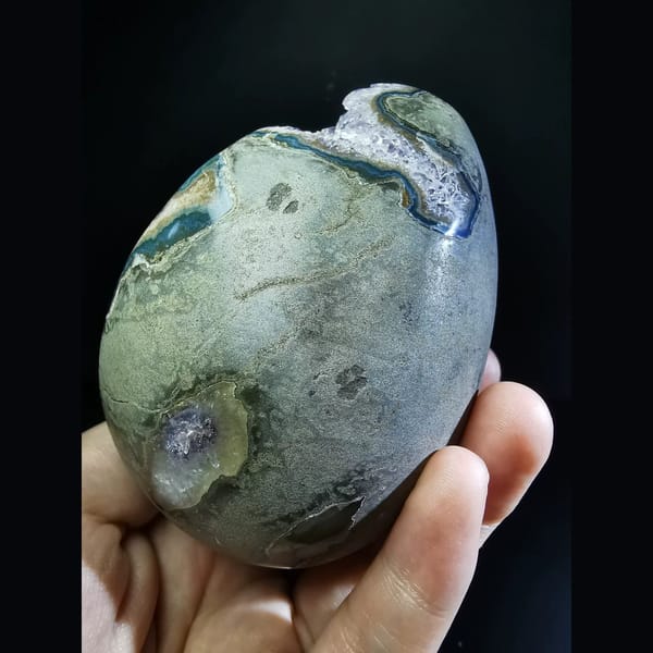 Deep Uruguayan amethyst geode with a blue agate rim — detail view