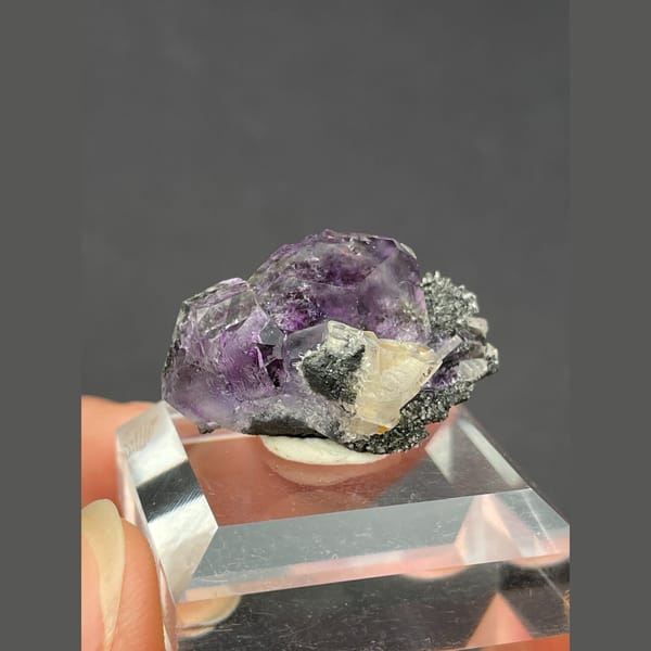 Small tanzanite blue-violet fluorite on matrix from Fujian — alternate view