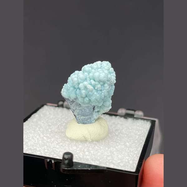 Small rounded pale blue gibbsite spheres from Yunnan — complete view