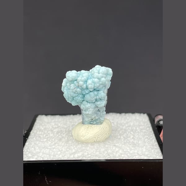 Small rounded pale blue gibbsite spheres from Yunnan — alternate view