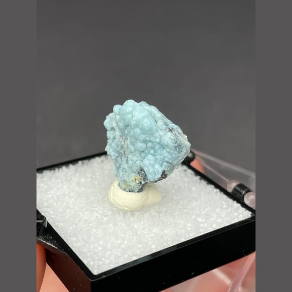 Cluster of frosted pale blue gibbsite spheres from Yunnan — detail view